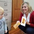 Annelise Pieterse, mom of the deputy Head Boy Conley for 2019, shows her voucher for the Vicky Butchery Prize to her young friend, Reid.
